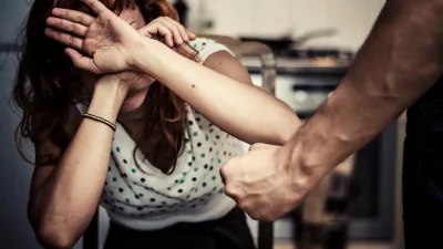 DFMBNE Young woman covering her face in fear of domestic violence