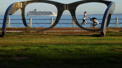 A lady runs with a pram along the Sea Point Promenade as The World, an exclusive private residential ship during its 2024 journey to six continents, arrives in Cape Town, South Africa, February 28, 2024. REUTERS/Esa Alexander   TPX IMAGES OF THE DAY