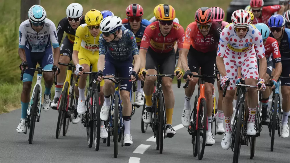 Denmark's Jonas Vingegaard, fourth left, turns back to look at Slovenia's Tadej Pogacar, wearing the overall leader's yellow jersey, during the thirteenth stage of the Tour de France cycling race over 165.3 kilometers (102.7 miles) with start in Agen and finish Pau, France, Friday, July 12, 2024. Right is Norway's Jonas Abrahamsen, the runner-up for the best climber's dotted jersey, which is held by Pogacar. (AP Photo/Jerome Delay)