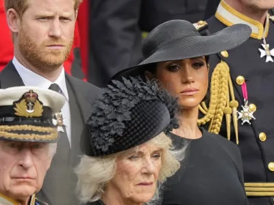 Britain's King Charles III, from bottom left, Camilla, the Queen Consort, Prince Harry and Meghan, Duchess of Sussex watch as the coffin of Queen Elizabeth II is placed into the hearse following the state funeral service in Westminster Abbey in central London Monday Sept. 19, 2022. The Queen, who died aged 96 on Sept. 8, will be buried at Windsor alongside her late husband, Prince Philip, who died last year. (AP Photo/Martin Meissner, Pool)