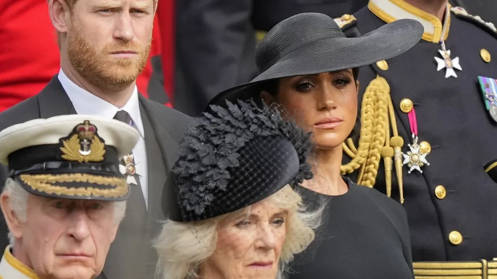 Britain's King Charles III, from bottom left, Camilla, the Queen Consort, Prince Harry and Meghan, Duchess of Sussex watch as the coffin of Queen Elizabeth II is placed into the hearse following the state funeral service in Westminster Abbey in central London Monday Sept. 19, 2022. The Queen, who died aged 96 on Sept. 8, will be buried at Windsor alongside her late husband, Prince Philip, who died last year. (AP Photo/Martin Meissner, Pool)