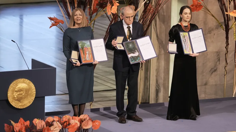 Representatives of the 2022 Nobel Peace Prize laureates, from left: Natalia Pinchuk, the wife of Nobel Peace Prize winner Ales Bialiatski, Yan Rachinsky, chairman of the International Memorial Board and Oleksandra Matviychuk, head of the Ukraine's Center for Civil Liberties pose with awards during the Nobel Peace Prize ceremony at Oslo City Hall, Norway, Saturday, Dec. 10, 2022. The winners of this year's Nobel Peace Prize from Ukraine, Russia and Belarus have shared their visions of a fairer world during an award ceremony and denounced Russian President Vladimir Putin's war in Ukraine. (AP Photo/ Markus Schreiber)