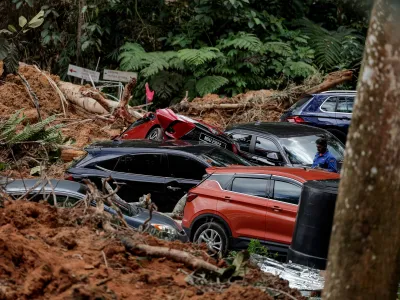 16 December 2022, Malaysia, Batang Kali: Damaged vehicles are seen at the site of a land collapse at the camping ground in Batang Kali. At least 10 people have died. Photo: Amirul Azmi/BERNAMA/dpa