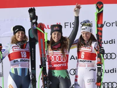 From left, second placed Slovenia's Ilka Stuhec, the winner Italy's Sofia Goggia, and third placed Germany's Kira Weidle celebrate on podium after an alpine ski, women's World Cup downhill race, in St. Moritz, Switzerland, Saturday, Dec. 17, 2022. (AP Photo/Marco Trovati)