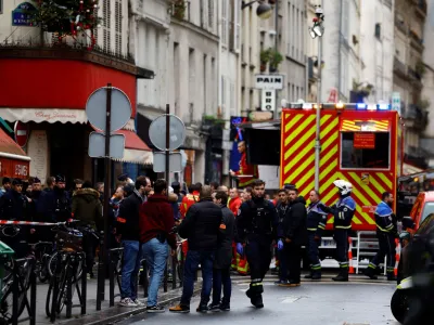 French police and firefighters secure a street after gunshots were fired killing two people and injuring several in a central district of Paris, France, December 23, 2022. REUTERS/Sarah Meyssonnier