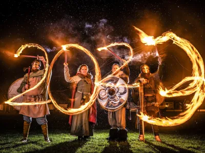 Viking reenactors use flaming torches to write 2023 at the Flamborough Fire Festival, a Viking themed parade in aid of charities and local community groups, held on New Year's Eve in Flamborough near Bridlington, England, Saturday Dec. 31, 2022. (Danny Lawson/PA via AP)