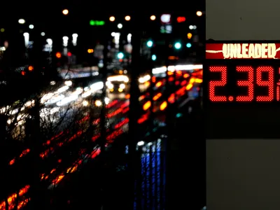 FILE - Cars blur past a gas station sign displaying the price of regular unleaded gasoline Tuesday, Dec. 13, 2022, in Benton, Mo. According to the December Associated Press-NORC Center for Public Affairs Research poll, Republicans and Democrats have distinct views of what's most important for the government to address amid high inflation. More Republicans name gas and food prices, energy and immigration; more Democrats focus on health care, climate change and poverty. (AP Photo/Charlie Riedel, File)