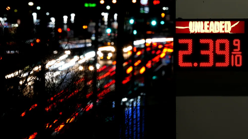 FILE - Cars blur past a gas station sign displaying the price of regular unleaded gasoline Tuesday, Dec. 13, 2022, in Benton, Mo. According to the December Associated Press-NORC Center for Public Affairs Research poll, Republicans and Democrats have distinct views of what's most important for the government to address amid high inflation. More Republicans name gas and food prices, energy and immigration; more Democrats focus on health care, climate change and poverty. (AP Photo/Charlie Riedel, File)