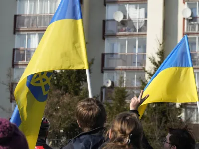 Protestors wave Ukrainian flags as they participate in a demonstration, in front of a building housing Russian diplomats, in Warsaw, Poland, Sunday, March 13, 2022. Russia has escalated attacks in western Ukraine, striking a military base where its troops had trained with NATO forces and bringing the conflict closer to Poland and other members of the bloc. (AP Photo/Czarek Sokolowski)