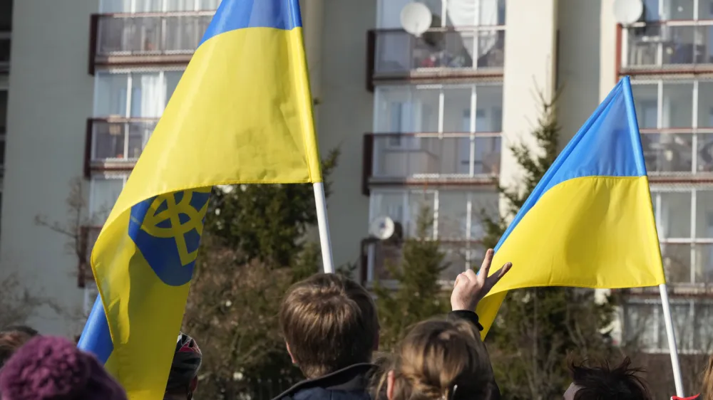 Protestors wave Ukrainian flags as they participate in a demonstration, in front of a building housing Russian diplomats, in Warsaw, Poland, Sunday, March 13, 2022. Russia has escalated attacks in western Ukraine, striking a military base where its troops had trained with NATO forces and bringing the conflict closer to Poland and other members of the bloc. (AP Photo/Czarek Sokolowski)