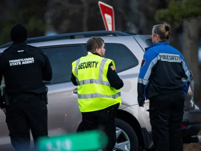 Security workers and Pennsylvania State Agents stand guard at the gate of the private Indian Mountain Lake community after Pennsylvania State Police took into custody Bryan Kohberger, a 28-year-old suspect wanted in the killings of four University of Idaho students, in Albrightsville, Pennsylvania, U.S., December 30, 2022. REUTERS/Eduardo Munoz