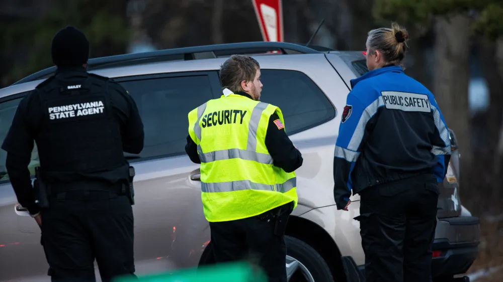 Security workers and Pennsylvania State Agents stand guard at the gate of the private Indian Mountain Lake community after Pennsylvania State Police took into custody Bryan Kohberger, a 28-year-old suspect wanted in the killings of four University of Idaho students, in Albrightsville, Pennsylvania, U.S., December 30, 2022. REUTERS/Eduardo Munoz