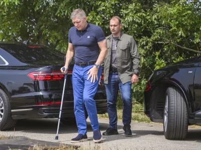 Slovak Prime Minister Robert Fico using a crutch, arrives to attend a press conference during harvest in the village of Slovenska Nova Ves, western Slovakia, Monday, July 8, 2024. Fico is recovering after being seriously wounded in an assassination attempt on May 15. (Jaroslav Novak/TASR via AP)