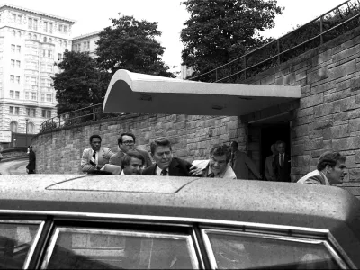 FILE - President Ronald Reagan being shoved into the President's limousine by secret service agents after being shot outside a Washington hotel, March 30, 1981.  (AP Photo/Ron Edmonds)