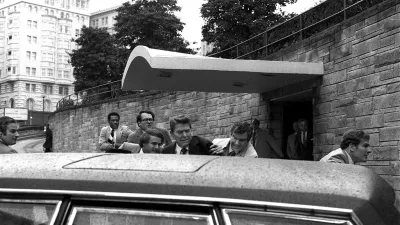 FILE - President Ronald Reagan being shoved into the President's limousine by secret service agents after being shot outside a Washington hotel, March 30, 1981.  (AP Photo/Ron Edmonds)