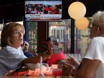 A television in a restaurant shows the news after reports of multiple shots fired and apparent injuries to Republican presidential candidate former U.S. President Donald Trump at his rally in Pennsylvania, outside the site of the 2024 Republican National Convention in Milwaukee, Wisconsin, U.S., July 13, 2024. REUTERS/Brian Snyder