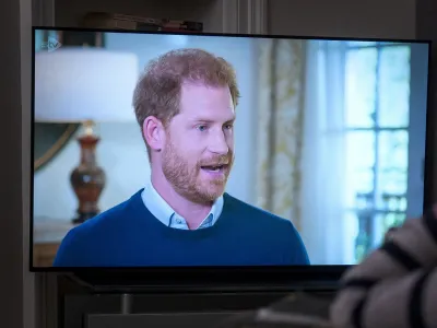 A person at home in Edinburgh watches Prince Harry, the Duke of Sussex, being interviewed by ITV's Tom Bradby, during "Harry: The Interview," two days before his controversial autobiography "Spare" is published, Sunday, Jan. 8, 2023. (Jane Barlow/PA via AP)