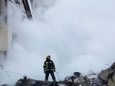 An emergency personnel looks on at the site where an apartment block was heavily damaged by a Russian missile strike, amid Russia's attack on Ukraine, in Dnipro, Ukraine January 15, 2023. REUTERS/Clodagh Kilcoyne