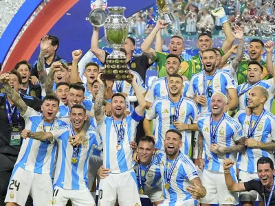 Lionel Messi hoists the trophy after Argentina defeated Colombia in the Copa America final soccer match in Miami Gardens, Fla., Monday, July 15, 2024. (AP Photo/Julio Cortez)