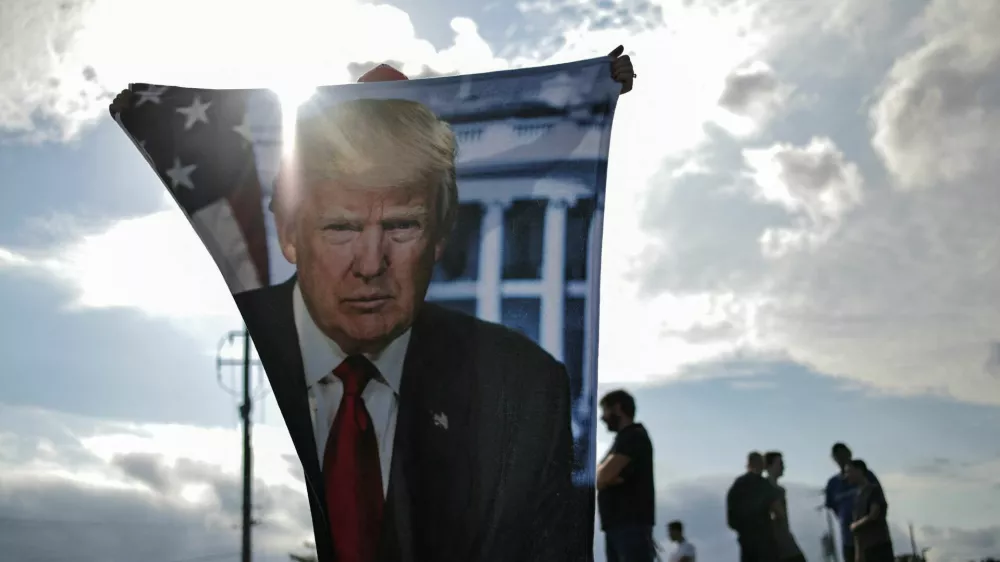 Supporters of Republican presidential candidate and former U.S. President Donald Trump wait for his arrival in Milwaukee, Wisconsin, U.S., July 14, 2024 a day after he survived an assassination attempt at a rally in Butler, Pennsylvania. REUTERS/Carlos Barria