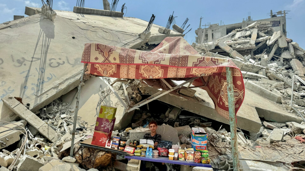 A Palestinian boy sits amidst the rubble of buildings destroyed after an Israeli strike, amid the ongoing conflict between Israel and Hamas, in Khan Younis, in the southern Gaza Strip, July 14, 2024. REUTERS/Mohammed Salem