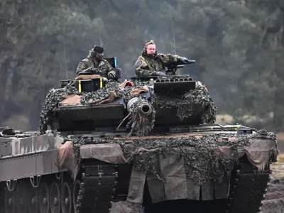 German Defense Minister Boris Pistorius rides a tank as he visits the Leopard II tanks that are due to be supplied to Ukraine at the tank brigade Lipperland of Germany's army and part of the Bundeswehr, in Augustdorf, Germany, February 1, 2023. REUTERS/Benjamin Westhoff