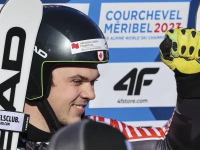 Canada's James Crawford celebrates in the finish area after completing an alpine ski, men's World Championship super-G race, in Courchevel, France, Thursday, Feb. 9, 2023. (AP Photo/Marco Trovati)