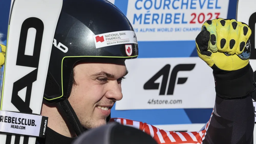 Canada's James Crawford celebrates in the finish area after completing an alpine ski, men's World Championship super-G race, in Courchevel, France, Thursday, Feb. 9, 2023. (AP Photo/Marco Trovati)