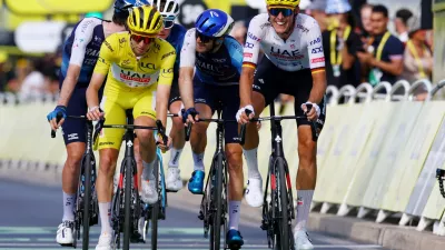 Cycling - Tour de France - Stage 16 - Gruissan to Nimes - Gruissan, France - July 16, 2024 UAE Team Emirates' Tadej Pogacar crosses the finish line with UAE Team Emirates' Nils Politt after stage 16 REUTERS/Molly Darlington