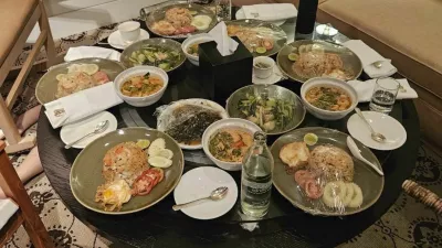 In this photo released by the Royal Thai Police, uneaten meals are left on a table in a room in the Grand Hyatt Erawan Hotel room where six people were found dead from unknown causes, Tuesday, July 16, 2024. Police said the dead in a rooms at Bangkok's Grand Hyatt Hotel were two Vietnamese Americans and four Vietnamese nationals, and speculated they might have died from some kind of poisoning. (Royal Thai Police via AP)