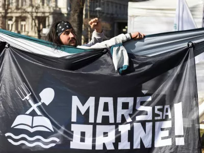 FILE PHOTO: An activist is seen in front of a banner that reads "Get off the Drina" as activists set up tents demanding ban on lithium exploitation in Belgrade, Serbia, February 11, 2022. REUTERS/Zorana Jevtic/File Photo