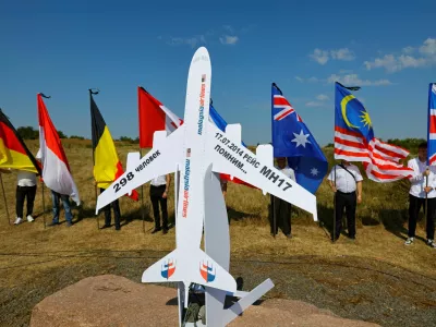 People hold flags at a memorial to victims of the Malaysia Airlines Flight MH17 plane crash during a ceremony marking the 10th anniversary of the accident, near the village of Hrabove (Grabovo) in the Donetsk region, Russian-controlled Ukraine, July 17, 2024. REUTERS/Alexander Ermochenko