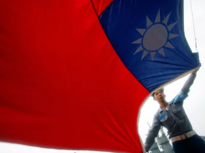 FILE PHOTO: A sailor holds a Taiwan flag on the Navy's 124th fleet Lafayette frigate during a model units tour organised by the Taiwan Ministry of National Defense, in Kaohsiung, August 28, 2008. REUTERS/Nicky Loh/File Photo