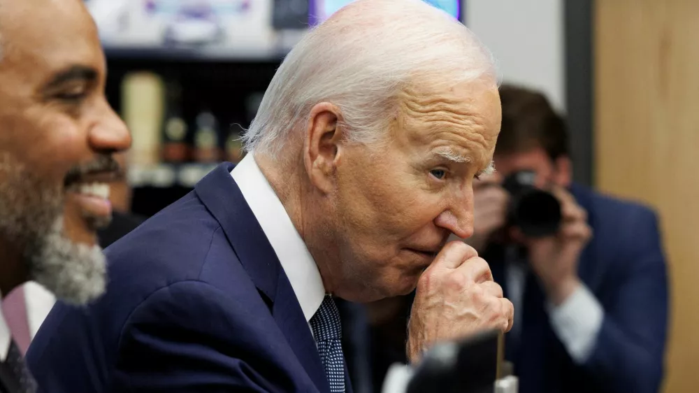 U.S. President Joe Biden rubs his nose while greeting shoppers inside Mario's Westside Market grocery store in Las Vegas, Nevada, U.S., July 16, 2024. REUTERS/Tom Brenner