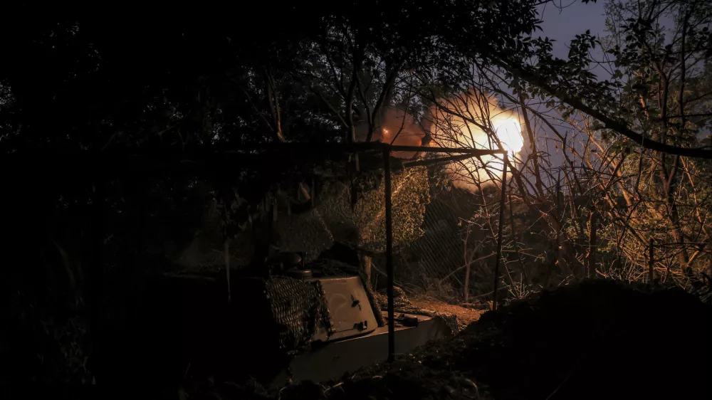 In this photo provided by Ukraine's 24th Mechanised Brigade press service, servicemen of the 24th Mechanised Brigade fire 155mm M-109 "Paladin" howitzer towards Russian forces near the frontline town of Chasiv Yar, Donetsk region, Ukraine, Saturday, July 20, 2024. (Oleg Petrasiuk/Ukrainian 24th Mechanised Brigade via AP)