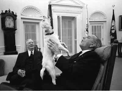 President Lyndon B. Johnson sings with his dog Yuki as Ambassador David Bruce looks on in the Oval Office of the White House, Washington, D.C. February 6, 1968. Yoichi Okamoto/LBJ Library/Handout via REUTERS THIS IMAGE HAS BEEN SUPPLIED BY A THIRD PARTY