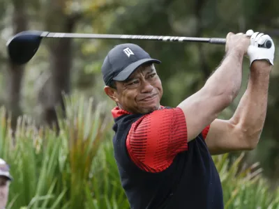 FILE - Tiger Woods tees off of the 3rd hole during the final round of the PNC Championship golf tournament on Dec. 18, 2022, in Orlando, Fla. Woods is returning to competition for the first time without the use of a cart since July, announcing Friday, Feb. 10, 2023, that he will play next week at Riviera in the Genesis Invitational. (AP Photo/Kevin Kolczynski, File)