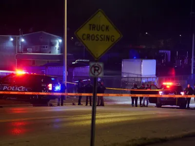 Police officers surround a scene where the suspect was located as they respond to a shooting at Michigan State University in East Lansing, Michigan, U.S., February 14, 2023.  REUTERS/Dieu-Nalio Chery 