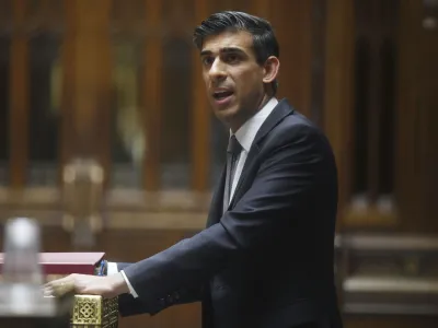 In this handout photo provided by UK Parliament, Britain's Chancellor of the Exchequer Rishi Sunak delivering his Spring Statement in the House of Commons in the House of Commons in London, Wednesday, March 23, 2022. Sunak announced a package of tax cuts and support payments that fell far short of what consumer advocates had demanded to shield working families from the soaring cost of living, triggering criticism that he doesn't understand the scale of the crisis. (Jessica Taylor/UK Parliament via AP)