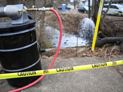 A view of a caution tape as members of the U.S. Environmental Protection Agency (EPA) (not pictured) inspect the site of a train derailment of hazardous material in East Palestine, Ohio, U.S., February 16, 2023. REUTERS/Alan Freed