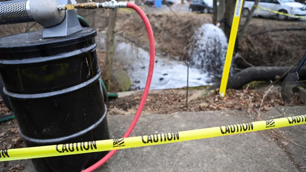 A view of a caution tape as members of the U.S. Environmental Protection Agency (EPA) (not pictured) inspect the site of a train derailment of hazardous material in East Palestine, Ohio, U.S., February 16, 2023. REUTERS/Alan Freed