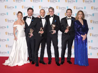 19 February 2023, United Kingdom, London: Geri Halliwell Horner (L) and Rita Wilson (R) pose with Viktor Prasil, Markus Stemler, Frank Kruse and Lars Ginzel, who won the Best Sound award for the film 'All Quiet on the Western Front', in the press room of the 76th British Academy Film Awards held at the Southbank Centre's Royal Festival Hall. Photo: Ian West/PA Wire/dpa