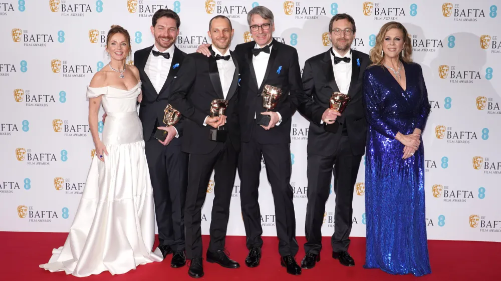 19 February 2023, United Kingdom, London: Geri Halliwell Horner (L) and Rita Wilson (R) pose with Viktor Prasil, Markus Stemler, Frank Kruse and Lars Ginzel, who won the Best Sound award for the film 'All Quiet on the Western Front', in the press room of the 76th British Academy Film Awards held at the Southbank Centre's Royal Festival Hall. Photo: Ian West/PA Wire/dpa