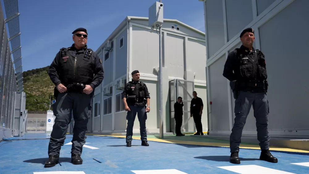 Italian police officers stand inside the reception camp at the port where Italy will process migrants, as Italy's Prime Minister Giorgia Meloni visits the sites, in Shengjin, Albania June 5, 2024. REUTERS/Florion Goga