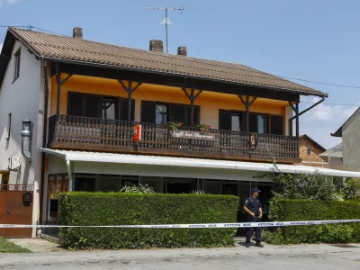 A police officer stands outside the cafe where the shooter was arrested, in Daruvar, central Croatia, Monday, July 22, 2024. An armed assailant entered a care home for older people in central Croatia Monday and opened fire, killing five people and wounding several others, authorities and media reports said. (Zeljko Puhovski/Cropix via AP)