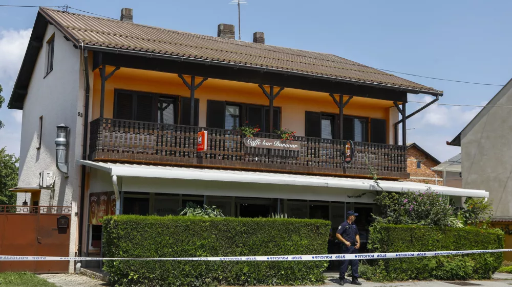 A police officer stands outside the cafe where the shooter was arrested, in Daruvar, central Croatia, Monday, July 22, 2024. An armed assailant entered a care home for older people in central Croatia Monday and opened fire, killing five people and wounding several others, authorities and media reports said. (Zeljko Puhovski/Cropix via AP)