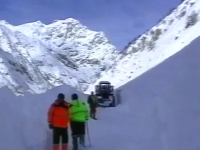 In this image made from Russia's RTR television channel, vehicles traverse a snowslide covering a road near Tajikistan's capital Dushanbe, Saturday, Dec. 22, 2007. A snow avalanche hit a key road near Tajikistan's capital, killing at least 15 people, an Interior Ministry spokesman said Saturday. (AP Photo/RTR-Russian Television Channel) ** TV OUT **