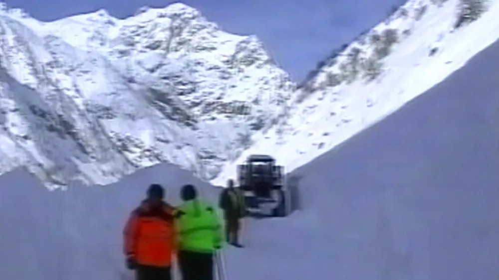 In this image made from Russia's RTR television channel, vehicles traverse a snowslide covering a road near Tajikistan's capital Dushanbe, Saturday, Dec. 22, 2007. A snow avalanche hit a key road near Tajikistan's capital, killing at least 15 people, an Interior Ministry spokesman said Saturday. (AP Photo/RTR-Russian Television Channel) ** TV OUT **