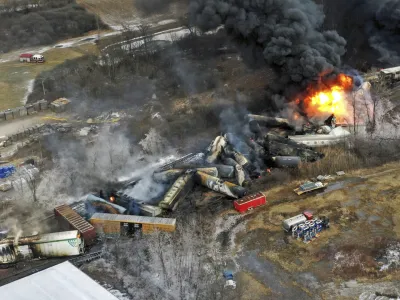 FILE - In this photo taken with a drone, portions of a Norfolk Southern freight train that derailed the previous night in East Palestine, Ohio, remain on fire at mid-day on Feb. 4, 2023. Transportation Secretary Pete Buttigieg announced a package of reforms to improve safety Tuesday, Feb. 21 — two days after he warned the railroad responsible for the derailment, Norfolk Southern, to fulfill its promises to clean up the mess just outside East Palestine, and help the town recover. (AP Photo/Gene J. Puskar, File)