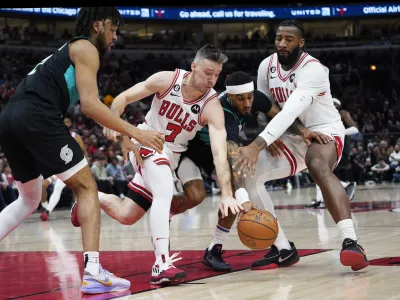 Feb 4, 2023; Chicago, Illinois, USA; Chicago Bulls guard Goran Dragic (7) and Chicago Bulls center Andre Drummond (right) and Portland Trail Blazers guard Gary Payton II (00) go for a loose ball during the first quarter at United Center. Mandatory Credit: David Banks-USA TODAY Sports